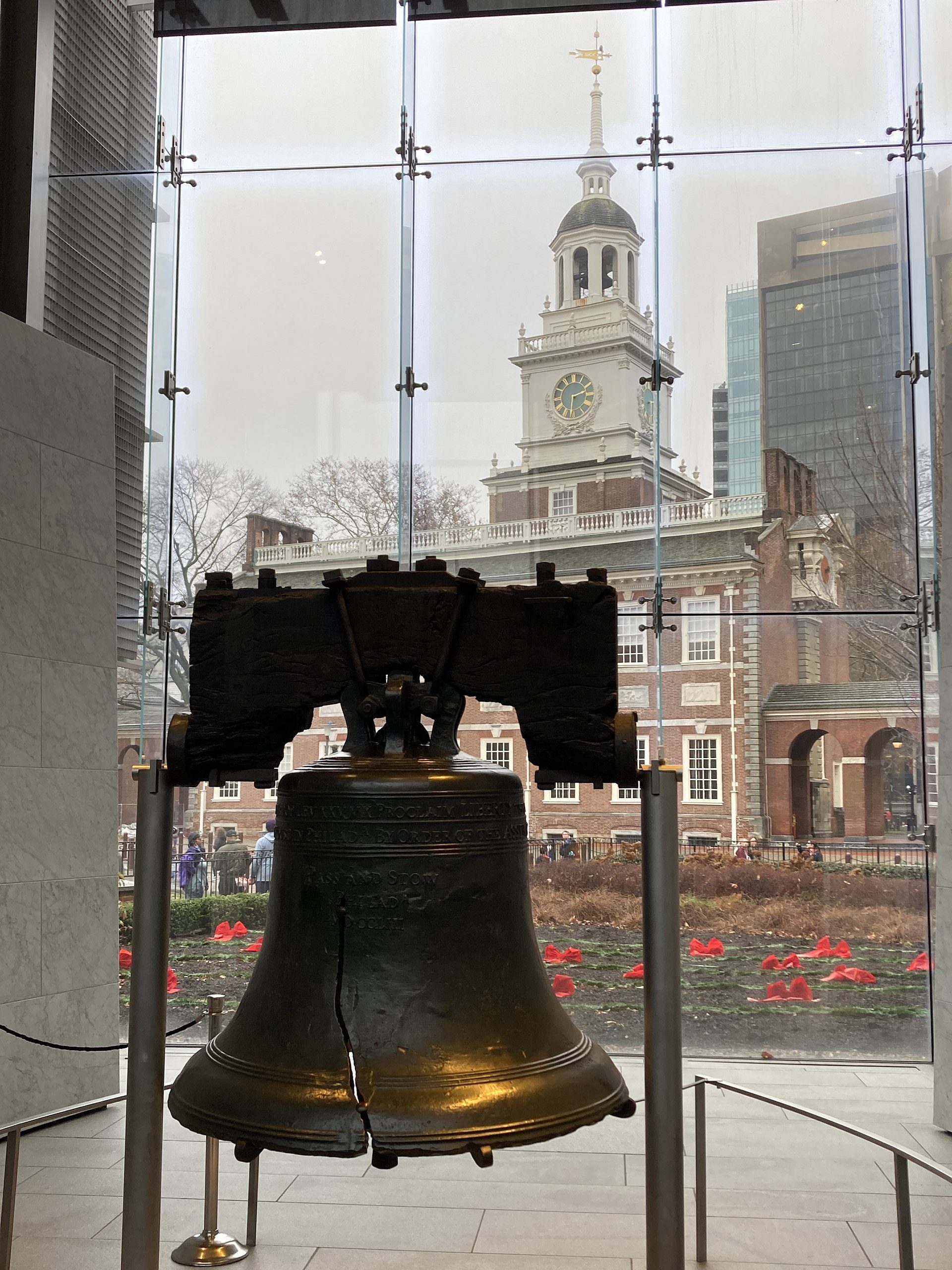 The Liberty Bell in its glass pavilion, with Independence Hall visible behind it.
